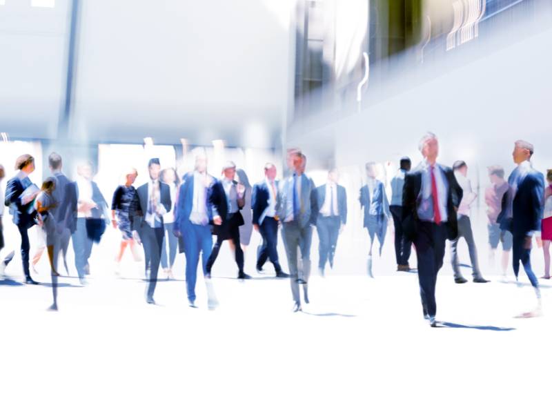 People in business suits walking in different directions